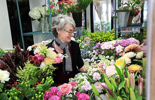 RUTH BONNEVILLE / WINNIPEG FREE PRESS 

Biz - Norwood Florist 

Photo of Michele Pitre, owner of Norwood Florist Design Studio, scene through the doors of her fridge full of beautiful flowers as she puts together a bouquet for a customer on Tuesday.  


Subject: Story on pandemic supply chain issues that florists are facing heading into Mothers' Day, the busiest week of the year for the industry. Business has been up by 30 per cent during the past year because people are sending more flowers since they can't meet in person. But Pitre at Norwood Florists asks customers to be patient because sometimes she doesn't even know what she's getting form the wholesalers



April 27,  2021