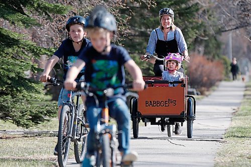 JOHN WOODS / WINNIPEG FREE PRESS
Meghan Cameron photographed with her children, left to right, Griffin, Magnus and Beatrix as they ride their bikes outside their home in Winnipeg Tuesday, April 27, 2021. Cameron and her family invested in a cargo bike, which she used to transport her children and to pick up groceries. The Camerons also compost and are trying to be more green.

Reporter: Sabrina
