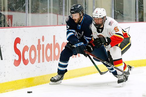 JOHN WOODS / WINNIPEG FREE PRESS
Manitoba Moose Haralds Egle (49) and Stockton Heats Colton Poolman (5) chase down a puck during first period AHL action in Winnipeg on Thursday, April 29, 2021.

Reporter: ?