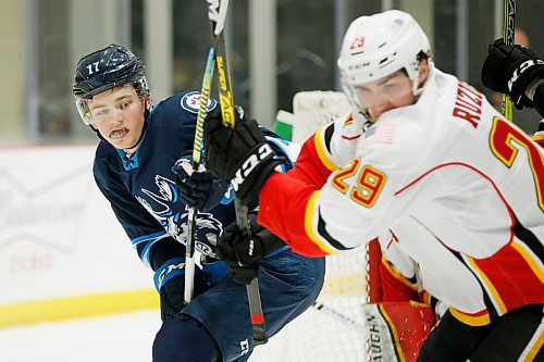 JOHN WOODS / WINNIPEG FREE PRESS
Manitoba Moose Cole Perfetti (17) skates against the Stockton Heats Adam Ruzicka (29) during first period AHL action in Winnipeg on Thursday, April 29, 2021.

Reporter: ?