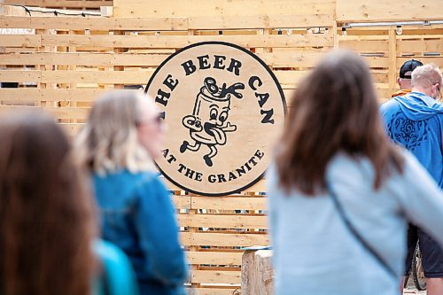 Daniel Crump / Winnipeg Free Press. The Beer Can at the Granite sign at the entrance to the venue is seen through people waiting in line to get in. May 1, 2021.