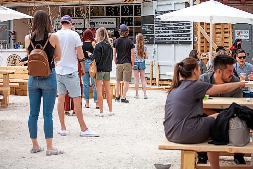 Daniel Crump / Winnipeg Free Press. People wait in line for to order drinks and food at the newly opened Beer Can Saturday afternoon. May 1, 2021.