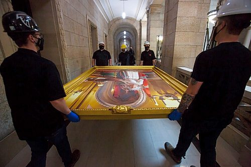 MIKE DEAL / WINNIPEG FREE PRESS
A crew from Total Co-ordination and Construction unloads and installs the Diamond Jubilee Portrait of Her Majesty Queen Elizabeth II which is on a cross country tour while Rideau Hall in Ottawa where it is normally on display undergoes construction. The painting will be in the Manitoba Legislative building room 200 for a year, until May 2022.
The portrait, which is part of the NCCs Crown Collection, was painted on the occasion of Her Majesty Queen Elizabeth IIs Diamond Jubilee by Phil Richards. It was officially unveiled in London, U.K., in 2012, in the presence of The Queen, the Right Honourable David Johnston, then-Governor General of Canada, and the Right Honourable Stephen Harper, then-Prime Minister of Canada. The painting was installed at Rideau Hall on June 28, 2012. That same year, it was the subject of a documentary produced by the National Film Board of Canada to show the various steps involved in creating the portrait and interviews with the artist. 
In late 2018, The Office of the Secretary to the Governor General of Canada (OSGG) announced that the Diamond Jubilee Portrait of Her Majesty Queen Elizabeth II, which has been on display in the Ballroom at Rideau Hall since 2012, would be undertaking a cross-country tour.
Since leaving Rideau Hall in September 2018, the portrait has been on display in St. Johns, N.L., as well as Fredericton, N.B. It will remain on display at the Manitoba Legislative Building until May 2022. Her Majesty will also celebrate Her Platinum Jubilee in 2022, marking 70 years since her accession to the throne.
The portrait will not be on public display until COVID restrictions are lifted, allowing for tours of the building to resume.
210503 - Monday, May 03, 2021.