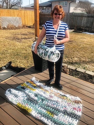 Canstar Community News Tracey Wenham shows off one of the sleeping mats she makes from old plastic grocery bags and deliver to those less fortunate as part of her Angel Wings With Love project.