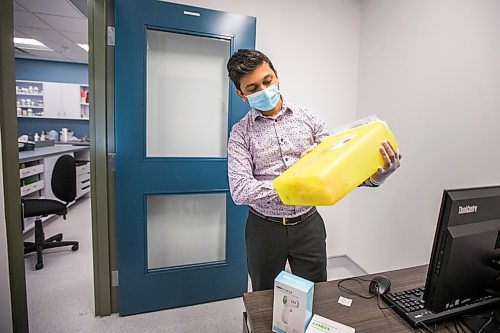 MIKAELA MACKENZIE / WINNIPEG FREE PRESS

Bhargav Desai, pharmacy manager at Peguis Pharmacy, poses for a photo with vaccine supplies (and the sharps bin with the 98 AstraZeneca/COVISHIELD vaccines he gave out) in Winnipeg on Wednesday, May 5, 2021. For Dylan & Erik story.
Winnipeg Free Press 2020.