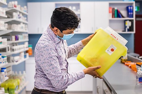 MIKAELA MACKENZIE / WINNIPEG FREE PRESS

Bhargav Desai, pharmacy manager at Peguis Pharmacy, poses for a photo with vaccine supplies (and the sharps bin with the 98 AstraZeneca/COVISHIELD vaccines he gave out) in Winnipeg on Wednesday, May 5, 2021. For Dylan & Erik story.
Winnipeg Free Press 2020.