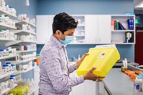 MIKAELA MACKENZIE / WINNIPEG FREE PRESS

Bhargav Desai, pharmacy manager at Peguis Pharmacy, poses for a photo with vaccine supplies (and the sharps bin with the 98 AstraZeneca/COVISHIELD vaccines he gave out) in Winnipeg on Wednesday, May 5, 2021. For Dylan & Erik story.
Winnipeg Free Press 2020.