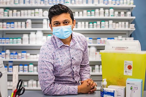 MIKAELA MACKENZIE / WINNIPEG FREE PRESS

Bhargav Desai, pharmacy manager at Peguis Pharmacy, poses for a photo with vaccine supplies (and the sharps bin with the 98 AstraZeneca/COVISHIELD vaccines he gave out) in Winnipeg on Wednesday, May 5, 2021. For Dylan & Erik story.
Winnipeg Free Press 2020.