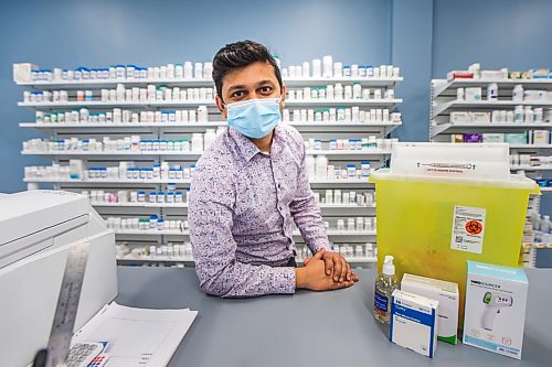 MIKAELA MACKENZIE / WINNIPEG FREE PRESS

Bhargav Desai, pharmacy manager at Peguis Pharmacy, poses for a photo with vaccine supplies (and the sharps bin with the 98 AstraZeneca/COVISHIELD vaccines he gave out) in Winnipeg on Wednesday, May 5, 2021. For Dylan & Erik story.
Winnipeg Free Press 2020.