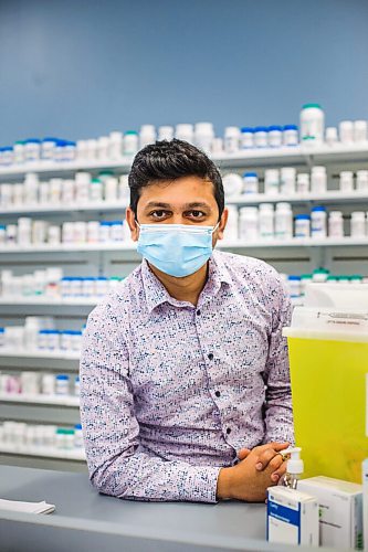 MIKAELA MACKENZIE / WINNIPEG FREE PRESS

Bhargav Desai, pharmacy manager at Peguis Pharmacy, poses for a photo with vaccine supplies (and the sharps bin with the 98 AstraZeneca/COVISHIELD vaccines he gave out) in Winnipeg on Wednesday, May 5, 2021. For Dylan & Erik story.
Winnipeg Free Press 2020.