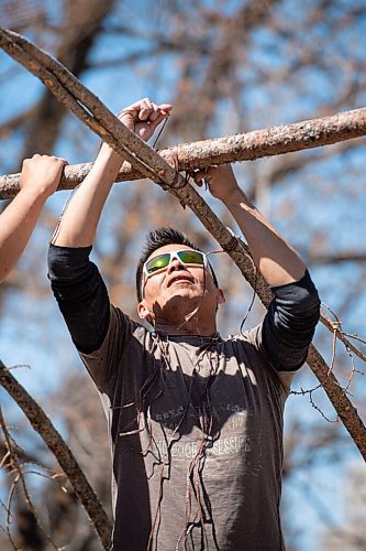 MIKE SUDOMA / WINNIPEG FREE PRESS  
(Left to right) Andrew Atkinson ties together the structure of a traditional midewiwin lodge on the river banks across from the Forks Market Friday afternoon. 
May 7, 2021