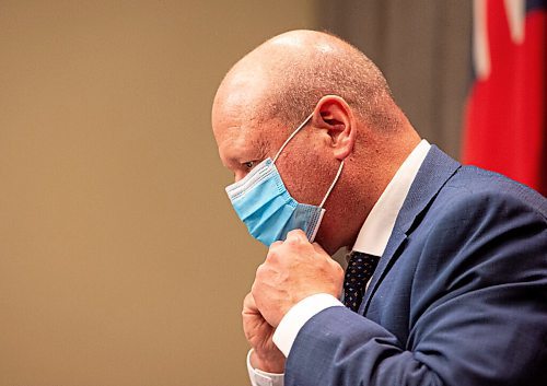 MIKE SUDOMA / WINNIPEG FREE PRESS  
Dr Brent Roussin tightens a disposable mask after announcing a tighter set of restrictions to prevent the spread of Covid 19 during a press conference at the Manitoba Legislative Building Friday evening
April 22, 2021