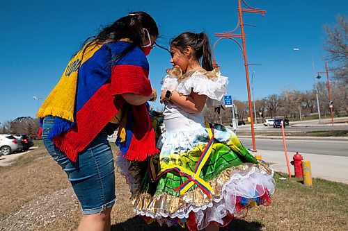 Daniel Crump / Winnipeg Free Press. Nancy Jimenez helps 8-year-old Isabella Meneses into her traditional joropo dress in preparation form a rally calling for an end to the violence against protestors in Colombia. Simultaneous rallied were held at the Canadian Museum for Human Rights and the Manitoba Legislature as well as a vehicle rally that looped between the two locations. May 8, 2021.