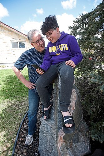 JOHN WOODS / WINNIPEG FREE PRESS
James Ham and his son Patrick, 12, video chat with his wife and mother, respectively, outside their home in Winnipeg Sunday, May 9, 2021. Patrick is spending Mothers Day without his mother, who is in Fargo, and wanted to call her to wish her a Happy Mothers Day.

Reporter: Durrani