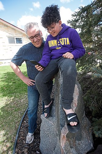 JOHN WOODS / WINNIPEG FREE PRESS
James Ham and his son Patrick, 12, video chat with his wife and mother, respectively, outside their home in Winnipeg Sunday, May 9, 2021. Patrick is spending Mothers Day without his mother, who is in Fargo, and wanted to call her to wish her a Happy Mothers Day.

Reporter: Durrani