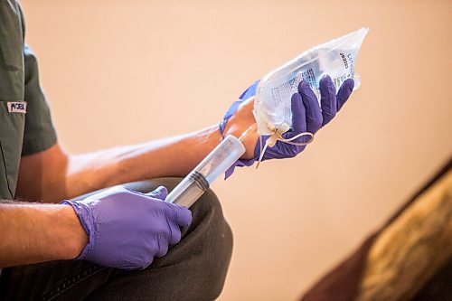 MIKAELA MACKENZIE / WINNIPEG FREE PRESS

Veterinarian Justin Rosing prepares subcutaneous fluids for the cub at the black bear rehabilitation centre near Stonewall on Sunday, April 25, 2021. For Eva Wasney story.
Winnipeg Free Press 2020.