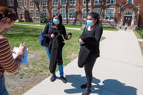 MIKE DEAL / WINNIPEG FREE PRESS
Anaya Aftab (left) and Adonaya Aftab (right), 16 year-old twins in grade 11, arrive for afternoon classes at Daniel McIntyre Collegiate Institute (720 Alverstone St.) in the West End on what might end up being the last day of school for the year if the pandemic numbers get worse in Manitoba.
See Maggie Macintosh story
210511 - Tuesday, May 11, 2021.
