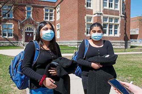 MIKE DEAL / WINNIPEG FREE PRESS
Anaya Aftab (left) and Adonaya Aftab (right), 16 year-old twins in grade 11, arrive for afternoon classes at Daniel McIntyre Collegiate Institute (720 Alverstone St.) in the West End on what might end up being the last day of school for the year if the pandemic numbers get worse in Manitoba.
See Maggie Macintosh story
210511 - Tuesday, May 11, 2021.