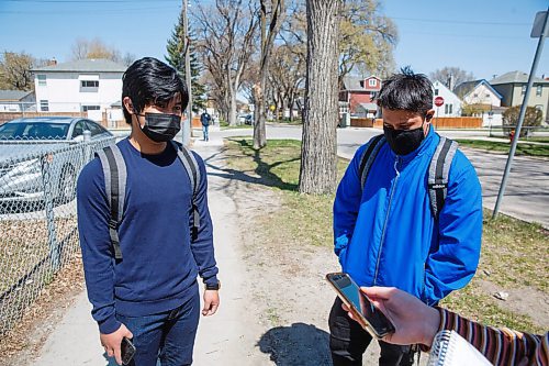 MIKE DEAL / WINNIPEG FREE PRESS
Students Yuan Eusbeio (left), 16, and Kenneth Besyk (right), 18, arrive for afternoon classes at Daniel McIntyre Collegiate Institute (720 Alverstone St.) in the West End on what might end up being the last day of school for the year if the pandemic numbers get worse in Manitoba.
See Maggie Macintosh story
210511 - Tuesday, May 11, 2021.