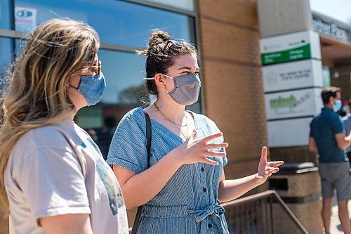 MIKAELA MACKENZIE / WINNIPEG FREE PRESS

Sophie (left) and Anica Warkentine speak to the Free Press while in line up to get vaccinated at the Ma Mawi Wi Chi Itata Centre walk-in clinic on the day that eligibility expanded to include all Manitobans over the age of 18 in Winnipeg on Wednesday, May 12, 2021. For Malak story.
Winnipeg Free Press 2020.