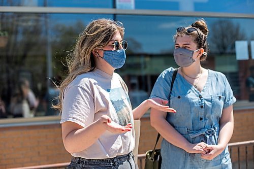 MIKAELA MACKENZIE / WINNIPEG FREE PRESS

Sisters Sophie (left) and Anica Warkentine speak to the Free Press while in line up to get vaccinated at the Ma Mawi Wi Chi Itata Centre walk-in clinic on the day that eligibility expanded to include all Manitobans over the age of 18 in Winnipeg on Wednesday, May 12, 2021. For Malak story.
Winnipeg Free Press 2020.