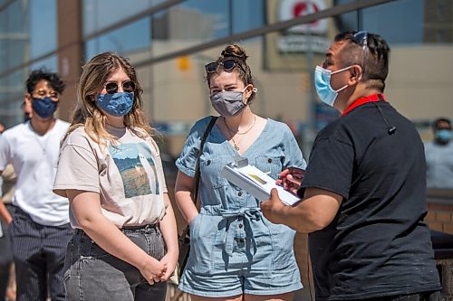 MIKAELA MACKENZIE / WINNIPEG FREE PRESS

Sisters Sophie (left) and Anica Warkentine line up to get vaccinated at the Ma Mawi Wi Chi Itata Centre walk-in clinic on the day that eligibility expanded to include all Manitobans over the age of 18 in Winnipeg on Wednesday, May 12, 2021. For Malak story.
Winnipeg Free Press 2020.