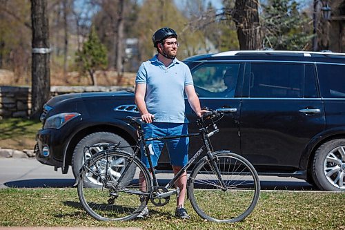 MIKE DEAL / WINNIPEG FREE PRESS
Cyclist Zach Fleisher on his bike at the intersection of Wellington Crescent and Guelph Street, wants enhanced summer cycling routes open as soon as possible and is concerned with current wait for them.
See Joyanne Pursaga story
210512 - Wednesday, May 12, 2021.