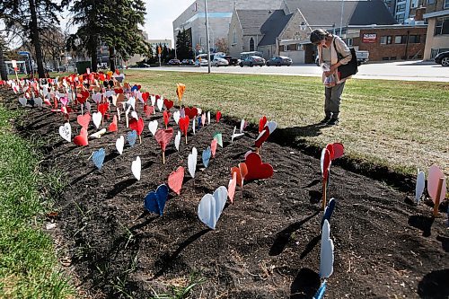 JOHN WOODS / WINNIPEG FREE PRESS
Eliza Chubb stops every time she passes to pray at a memorial for those who have died from COVID-19 has been setup on Osborne St N in Memorial Park in Winnipeg Wednesday, May 12, 2021. The 1000th person died today in Manitoba.

Reporter: Standup