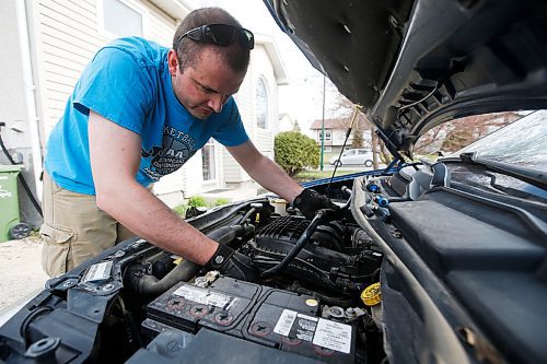 JOHN WOODS / WINNIPEG FREE PRESS
Keith Vandersluis, who took up car mechanics in the middle of the COVID-19 pandemic, works on his Dodge Grand Caravan outside his home in Winnipeg Thursday, March 13, 2021. 

Reporter: ?