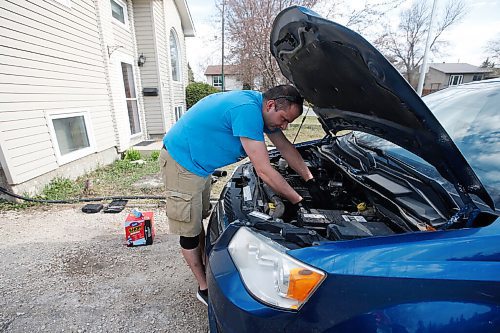 JOHN WOODS / WINNIPEG FREE PRESS
Keith Vandersluis, who took up car mechanics in the middle of the COVID-19 pandemic, works on his Dodge Grand Caravan outside his home in Winnipeg Thursday, March 13, 2021. 

Reporter: ?