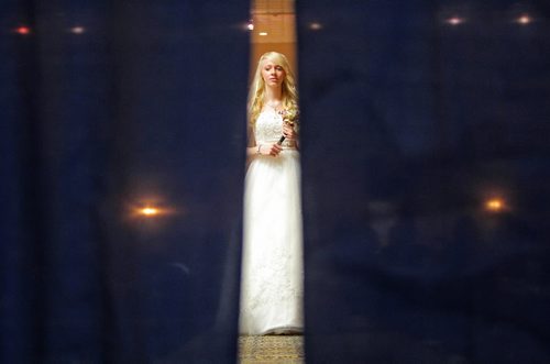 Brandon Sun 07032010 Lindsay Olson is seen through the backstage curtains as she models a wedding dress during Welcome Wagon's Bridal Showcase at the Royal Oak Inn and Suites on Victoria Ave. in Brandon on Sunday. Welcome Wagon will be celebrating their 80th Anniversary during a conference at the Royal Oak Inn on april 24th, 2010. (Tim Smith/Brandon Sun)