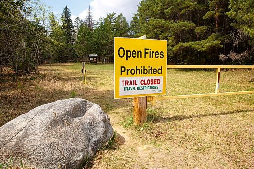 MIKE DEAL / WINNIPEG FREE PRESS
The entrance to the Hazelnut trial off of Hwy 206 into Birds Hill Provincial Park with a large "Open Fires Prohibited" sign Friday afternoon. 
The most recent restrictions announced by the province on May 13th include prohibitions on campfires and that camping is only allowed in developed campgrounds, so, no backcountry or wild camping.
210514 - Friday, May 14, 2021.
