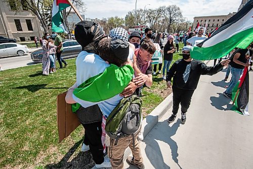 MIKE SUDOMA / WINNIPEG FREE PRESS  
Sam, a Jewish man supporting Palestine, gets hugged by a group of Palestinian protesters during a rally in memorial park Saturday afternoon
May 15, 2021