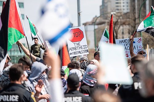 MIKE SUDOMA / WINNIPEG FREE PRESS  
Palestinian protesters taunt and hold up signs at opposing Israeli protesters at memorial park in downtown Winnipeg Saturday afternoon
May 15, 2021