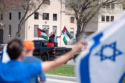 MIKE SUDOMA / WINNIPEG FREE PRESS  
Palestinian protester flips the middle finger to a group of Israeli protestors during a rally at memorial park in downtown Winnipeg Saturday afternoon due to the rising tensions over seas
May 15, 2021
