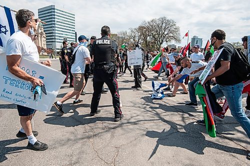 MIKE SUDOMA / WINNIPEG FREE PRESS  
A Palestinian protester grabs a flag of Israel from an opposing protester at a rally in memorial park in downtown Winnipeg Saturday afternoon 
May 15, 2021