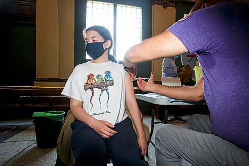 MIKE DEAL / WINNIPEG FREE PRESS
Dr. Barry Lavallee, CEO, Keewatinowi Inniniw Minoayawin, administers the Pfizer-BioNTech vaccine to Carley Hallett, 14, at the Aboriginal Health and Wellness Centre, 181 Higgins Ave., Winnipeg, early Monday morning.
210517 - Monday, May 17, 2021.