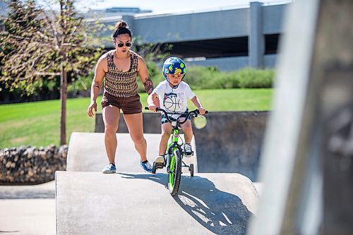 MIKAELA MACKENZIE / WINNIPEG FREE PRESS

Helene Estrada helps her son, Hero Estrada (five) go down a hill at the skate park on his bike at The Forks in Winnipeg on Tuesday, May 18, 2021. Standup.
Winnipeg Free Press 2020.