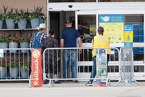 JOHN WOODS / WINNIPEG FREE PRESS
Three people. one masked, two unmasked, enter a Walmart in Winkler Tuesday, May 18, 2021. Winkler is the highest COVID positive cases after Winnipeg.

Reporter: Abas