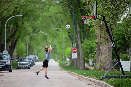 MIKAELA MACKENZIE / WINNIPEG FREE PRESS

Marko Shevchenko, nine, shoots some hoops alone during his recess break while distance learning at home in Wolseley in Winnipeg on Wednesday, May 19, 2021.  Standup.
Winnipeg Free Press 2020.