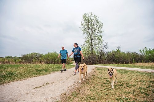 MIKAELA MACKENZIE / WINNIPEG FREE PRESS

Rick Mills and Ellen Reimann go for a walk with their dogs at the Transcona Bioreserve in Winnipeg on Wednesday, May 19, 2021.  Standup.
Winnipeg Free Press 2020.