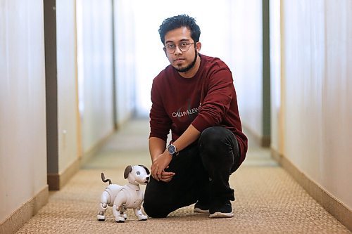 JOHN WOODS / WINNIPEG FREE PRESS
Rahatul Ananto, co-investigator in a U of MB  computer science study, spends time with an AIBO robot at his home in Winnipeg Wednesday, May 19, 2021. Ananto is a U of MB masters student in the Human Robotics Interaction program in the department of Computer Science and is looking for lonely people to live with the robot for 8 weeks. 

Reporter: Abas