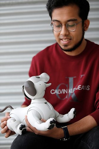 JOHN WOODS / WINNIPEG FREE PRESS
Rahatul Ananto, co-investigator in a U of MB  computer science study, spends time with an AIBO robot at his home in Winnipeg Wednesday, May 19, 2021. Ananto is a U of MB masters student in the Human Robotics Interaction program in the department of Computer Science and is looking for lonely people to live with the robot for 8 weeks. 

Reporter: Abas