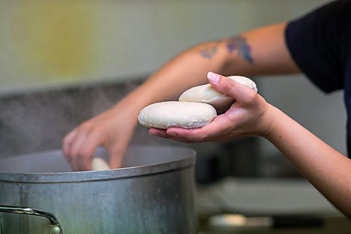 MIKAELA MACKENZIE / WINNIPEG FREE PRESS

Carter Bouchard, owner of Salt and Sunshine Bagels (a specialty bagel bakery she started on Instagram during the pandemic), whips up a batch of sesame bagels in her rented kitchen space at the Irish Association in Winnipeg on Thursday, May 20, 2021.  For Eva Wasney story.
Winnipeg Free Press 2020.