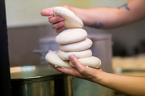 MIKAELA MACKENZIE / WINNIPEG FREE PRESS

Carter Bouchard, owner of Salt and Sunshine Bagels (a specialty bagel bakery she started on Instagram during the pandemic), whips up a batch of sesame bagels in her rented kitchen space at the Irish Association in Winnipeg on Thursday, May 20, 2021.  For Eva Wasney story.
Winnipeg Free Press 2020.