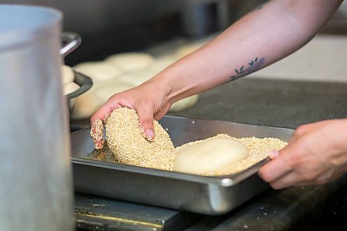 MIKAELA MACKENZIE / WINNIPEG FREE PRESS

Carter Bouchard, owner of Salt and Sunshine Bagels (a specialty bagel bakery she started on Instagram during the pandemic), whips up a batch of sesame bagels in her rented kitchen space at the Irish Association in Winnipeg on Thursday, May 20, 2021.  For Eva Wasney story.
Winnipeg Free Press 2020.