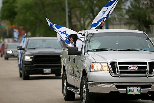 JOHN WOODS / WINNIPEG FREE PRESS
A person hangs out of a truck window during a car rally in support of Israels actions against Palestinians outside the Aper Jewish Community Centre in Winnipeg Thursday, May 20, 2021. 

Reporter: standup