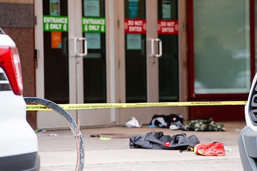 MIKE SUDOMA / WINNIPEG FREE PRESS  
Police tape blocks off a scene in front of the Portage Place Food court Friday morning as piles of clothes and blood line the entrance.
May 21, 2021