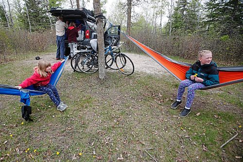 JOHN WOODS / WINNIPEG FREE PRESS
Madeline, left, and Ginny Knowles swing in hammocks as their parents Kaitlan Knowles and Steve Pratte pack up their camping long weekend early at Birds Hill Park just outside of Winnipeg Sunday, May 23, 2021. 

Reporter: JS