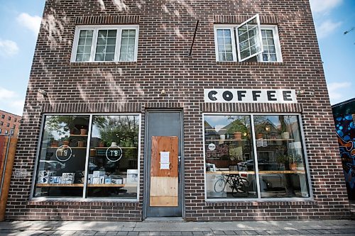 JOHN WOODS / WINNIPEG FREE PRESS
Wood covers a broken door at Thom Bargen Coffee on Sherbrook St in Winnipeg Monday, May 24, 2021. The store was broken into and a bike that was hanging on the wall was stolen.

Reporter: JS